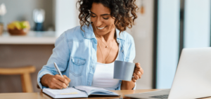 Mulher anotando ideias de nome para loja virtual
